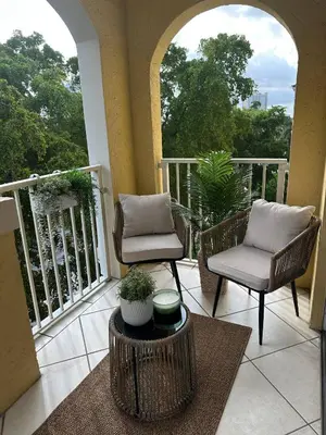 a balcony with two chairs and a table on a porch at Urban Luxe Aventura 22 Retreat in Aventura