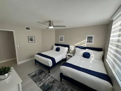 a hotel room with two beds and a room with at Urban Luxe Aventura 22 Retreat in Aventura