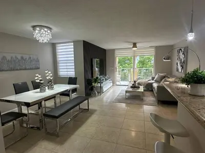 a living room with a table and a couch at Urban Luxe Aventura 22 Retreat in Aventura