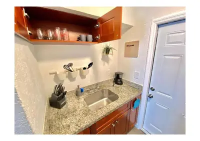a kitchen with a sink and a counter top at Cozy Place Near Design District - 2 in Miami