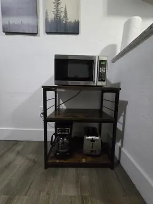 a microwave on a shelf in a room at Cozy Place Near Design District - 3 in Miami