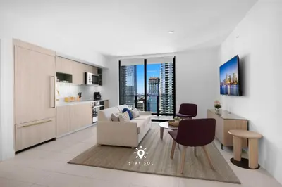 a kitchen and living room with a couch and a table at Modern Stylish Apt 2BR-2BTH in Miami