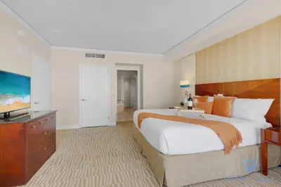 a bedroom with a large bed and a flat screen tv at Unique Apartment Miami Views in Sunny Isles Beach