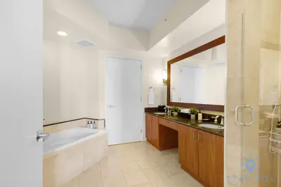 a bathroom with a tub and a sink and a bath tub at Unique Apartment Miami Views in Sunny Isles Beach