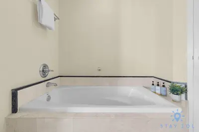a white bath tub in a white bathroom at Unique Apartment Miami Views in Sunny Isles Beach