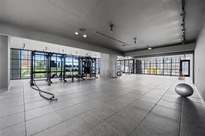a large room with a gym with large windows at 1BR Apartment - Pool & Gym in Miami