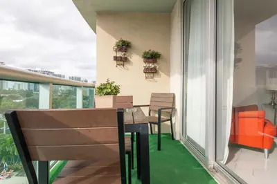 a balcony with a table and chairs on it at Ocean Reserve in South Island