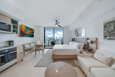 a bedroom with a bed and a living room at Lemon Drop - Modern Central & Full Amenities in Miami