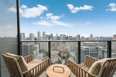 a balcony with chairs and a table and a city view at Lemon Drop - Modern Central & Full Amenities in Miami
