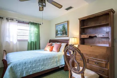 a bedroom with a bed and a dresser at Oasis1080 Resort in Plantation