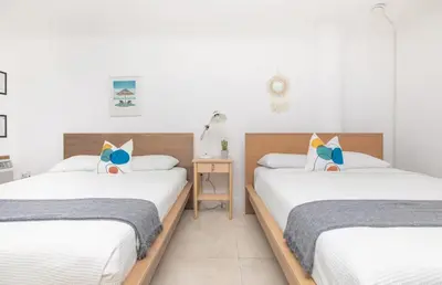 a bedroom with two beds and a nightstand between them at North Bay in Miami Beach
