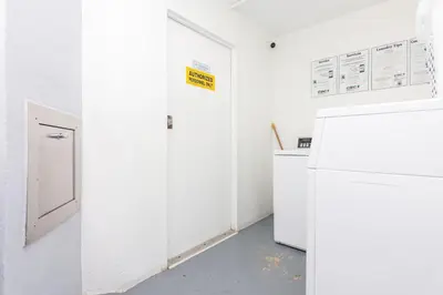 a white room with a refrigerator and a door at North Bay in Miami Beach