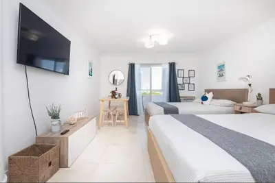 a hotel room with two beds and a flat screen tv at North Bay in Miami Beach