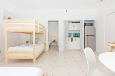 a room with a bunk bed and a kitchen at Ocean Villa in Miami Beach