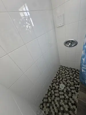 a bathroom with a shower with a tiled floor at Cozy place Near Design District - 1 in Miami