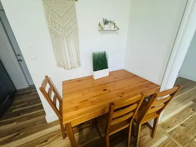 a wooden table and chairs in a room at Cozy place Near Design District - 1 in Miami