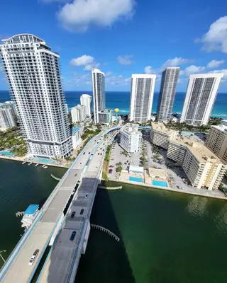a bridge over the water in a city with tall buildings at The Royal Studio of Beachwalk in Hallandale Beach