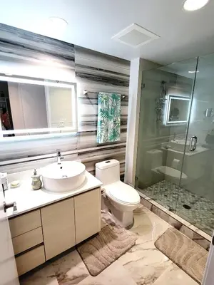 a bathroom with a sink and a toilet and a shower at The Royal Studio of Beachwalk in Hallandale Beach