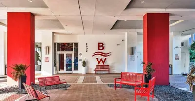 a lobby with red benches in a building at The Royal Studio of Beachwalk in Hallandale Beach