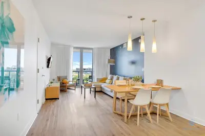 a living room with a table and a couch at Unique 2BR Apartment Gym & Pool in Hallandale Beach