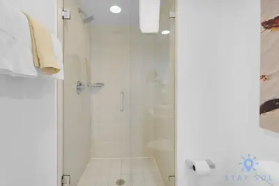 a bathroom with a shower with a glass door at Unique 2BR Apartment Gym & Pool in Hallandale Beach