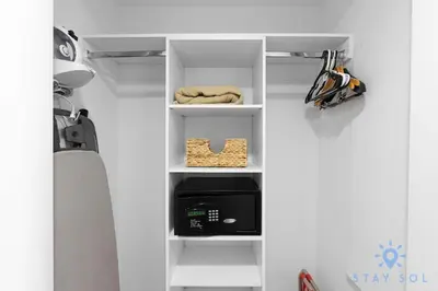 a closet with white shelves and a skateboard at Unique 2BR Apartment Gym & Pool in Hallandale Beach