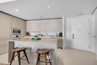 a kitchen with a counter and two bar stools at Ocean Views - Balcony & Resort Pool Paradise in Hollywood