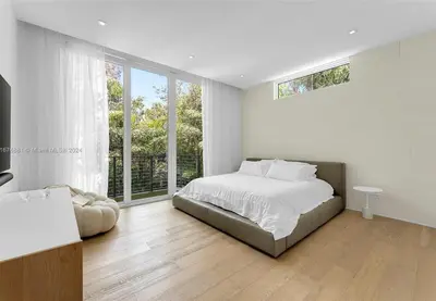 a white bedroom with a bed and a large window at Villa Tranquil Luxe Modern Oasis with Private Pool in Miami Beach in Miami Beach