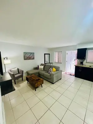 a living room with a couch and a table at Apartment in Hollywood close to shops & beach 108 in Hollywood