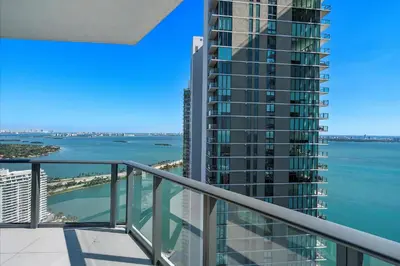 a balcony with a view of the ocean at POSH Ocean View Penthouse - Heated Pool, Gym, Office! 10mins Beach in Miami