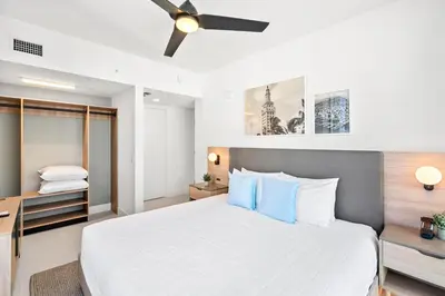 a bedroom with a large bed with a ceiling fan at New 26th floor amazing view 2BR-2BA in Miami