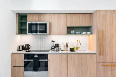 a kitchen with a stove and a microwave at New 26th floor amazing view 2BR-2BA in Miami