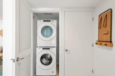 a laundry room with a washer and dryer next to a door at New 26th floor amazing view 2BR-2BA in Miami