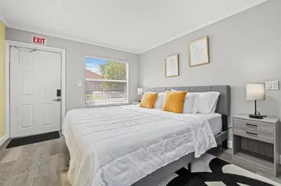 a bedroom with a large white bed with orange pillows at Fort Lauderdale Retreat Near Beach & Airport in Fort Lauderdale