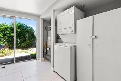 a kitchen with a refrigerator and a washer and dryer at Fort Lauderdale Retreat Near Beach & Airport in Fort Lauderdale