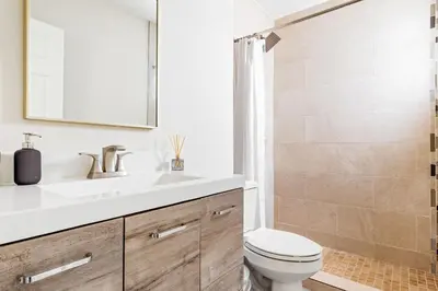 a bathroom with a sink and a toilet and a shower at Lux 6BR Villa with Pool, King Beds and Top Amenities in Miami