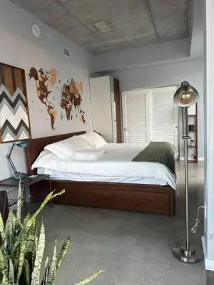 a bedroom with a large bed and a lamp at Luxury Loft 270 views, Rooftop Pool, Parking in Miami