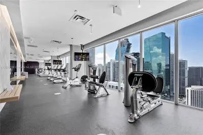a gym with treadmills and machines in a building at Luxury Loft 270 views, Rooftop Pool, Parking in Miami