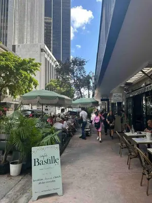 a restaurant with a sign for a restaurant with people sitting at tables at Luxury Loft 270 views, Rooftop Pool, Parking in Miami