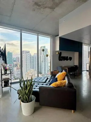 a living room with a couch and a large window at Luxury Loft 270 views, Rooftop Pool, Parking in Miami