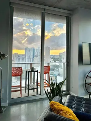 a living room with a couch and a large window at Luxury Loft 270 views, Rooftop Pool, Parking in Miami