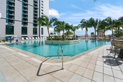 a swimming pool with palm trees and a building at NEW Suite Downtown Miami - Amazing view 27th floor in Miami