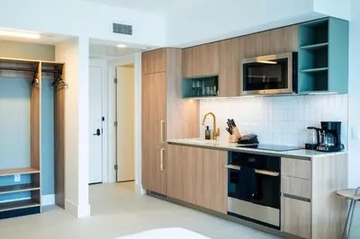 a kitchen with wooden cabinets and a counter top at NEW Suite Downtown Miami - Amazing view 27th floor in Miami