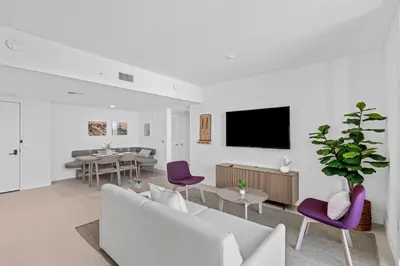 a living room with a couch and a tv on a wall at Stunning Views Dwntwn Miami 2BR Unit - Floor 28th in Miami