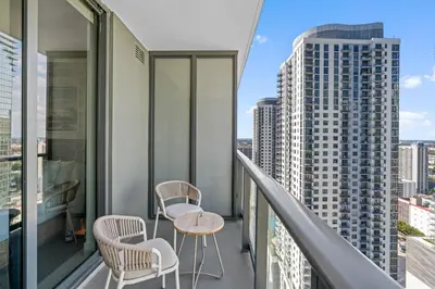 a balcony with two chairs and a table on a building at Stunning Views Dwntwn Miami 2BR Unit - Floor 28th in Miami