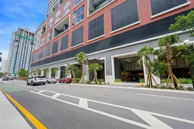a street with a building and cars parked on the street at Stylish Studio - Amazing Amenities & Pool in Miami