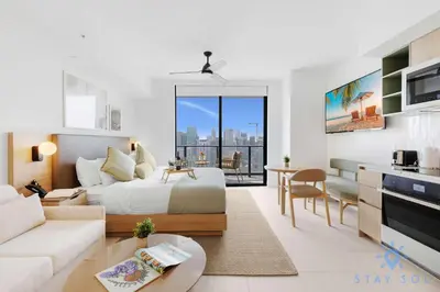 a bedroom with a bed and a living room at Stylish Studio - Amazing Amenities & Pool in Miami