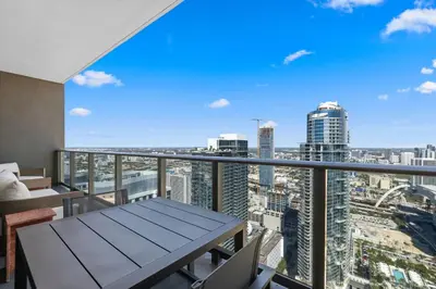 a balcony with a table and chairs and a view of the city at On The 49th Floor! Condo on Highest & Free Parking in Miami
