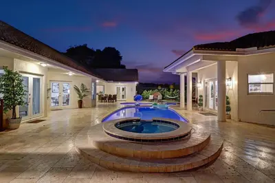 a swimming pool in the middle of a house at The Grand Luxe 8BR Villa w POOL and basketball in Pembroke Pines