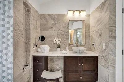 a bathroom with a sink and a mirror at The Grand Luxe 8BR Villa w POOL and basketball in Pembroke Pines